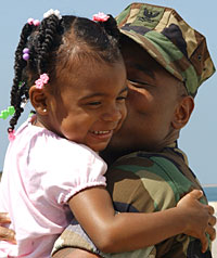 Daughter and soldier father hugging