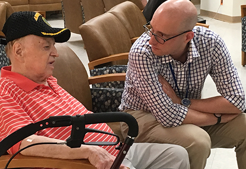 Photo of Dr. Jason Epstein talking with Veteran John Campbell.