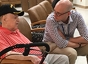 Photo of Dr. Jason Epstein talking with Veteran John Campbell.