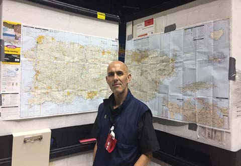Photo of Dr. Molloy in front of map of Puerto Rico