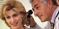 doctor checking womens ear
