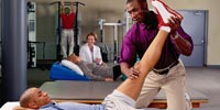 Physical Therapist working with patient
